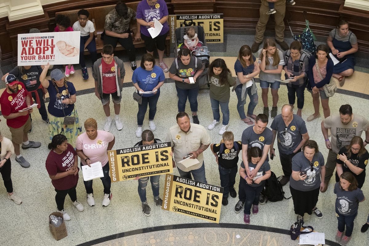 In this March 30, 2021 photo, pro-life demonstrators gather in the rotunda at the Capitol while the Senate debated anti-abortion bills in Austin, Texas. Even before a strict abortion ban took effect in Texas this week, clinics in neighboring states were fielding more and more calls from women desperate for options. The Texas law, allowed to stand in a decision Thursday, Sept. 2, 2021 by the U.S. Supreme Court, bans abortions after a fetal heartbeat can be detected, typically around six weeks.  (Jay Janner)