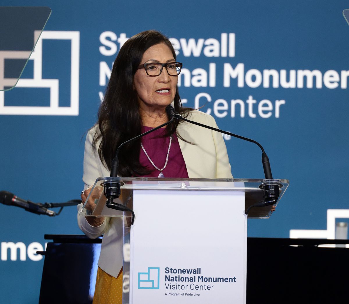 Above: Interior Secretary Deb Haaland attends the grand opening ceremony for the Stonewall National Monument Visitor Center on June 28 in New York City. Left: Native American boys farming at the Sherman Institute, a boarding school for Native Americans in Riverside, Calif., circa 1935. Founded by the U.S. Government in 1892, the school’s aim was to assimilate Native Americans into mainstream society.  (Dimitrios Kambouris)