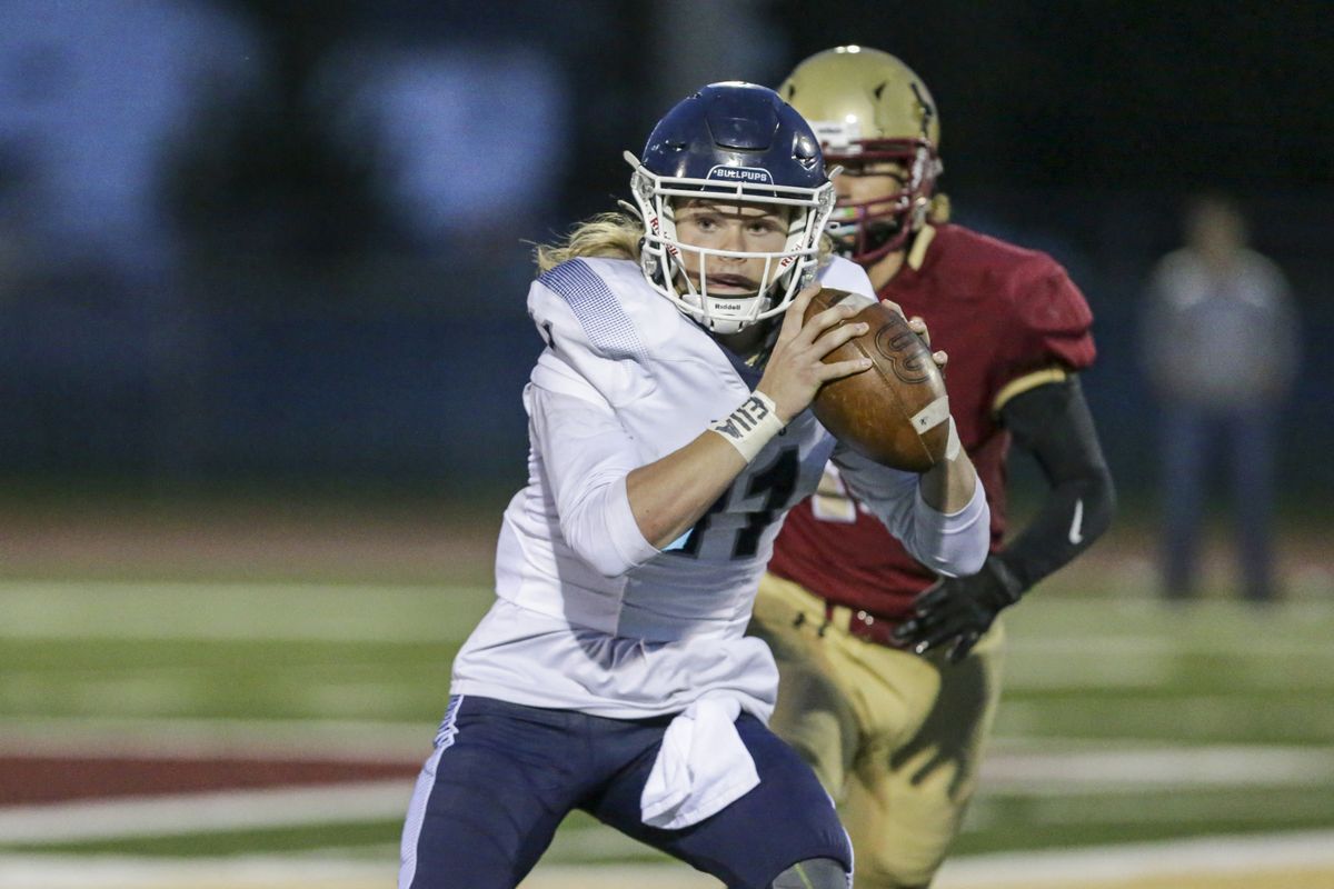 Gonzaga Prep quarterback Ryan McKenna looks for room to run in the Bullpups’ 49-0 win over University on Friday, Sept. 3, 2021.  (Cheryl Nichols/For The Spokesman-Review)