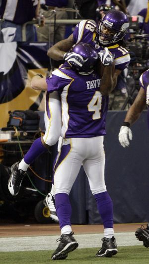 Brett Favre and Sidney Rice celebrate after one of their three TD connections, a 45-yard reception. (Associated Press)