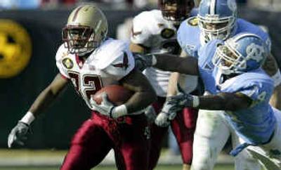 
Andre Callender  of Boston College eludes the grasp of North Carolina's Gerald Sensabaugh  during the first quarter of the Continental Tire Bowl. 
 (Associated Press / The Spokesman-Review)