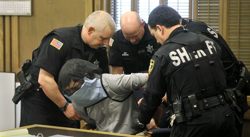 Correctional deputies secure Cole Strandberg to his chair in Superior Court Judge Tari Eitzen’s courtroom for his insanity hearing Feb. 16, 2011 in Spokane. Strandberg wore a spit guard over his head during the proceedings after he spit in his defense lawyer's face earlier in the week. (Dan Pelle)