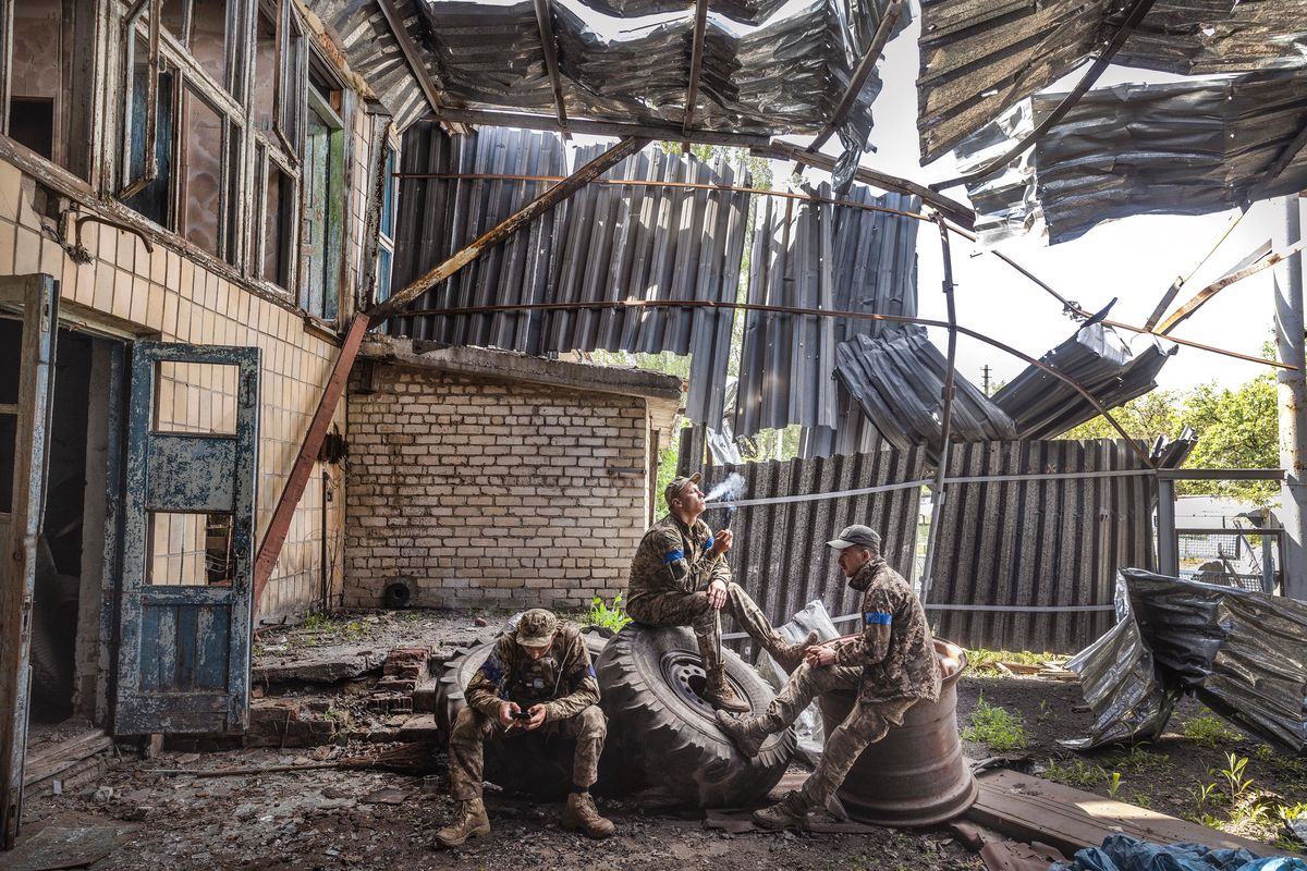 Soldiers from Ukraine’s 68th Brigade rest inside a destroyed and abandoned building on the outskirts of the recently-reclaimed village of Blahodatne, Ukraine on June 15. Seeking to bolster morale and Western support, President Volodymyr Zelensky and his aides say that the slow progress of Ukraine’s counteroffensive is to be expected.  (David Guttenfelder/The New York Times)