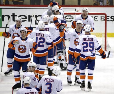 The New York Islanders celebrate at the end of Game 4 of an NHL hockey first-round playoff series against the Pittsburgh Penguins in Pittsburgh, Tuesday, April 16, 2019. The Islanders won 3-1, and swept the series. (Gene J. Puskar / Associated Press)