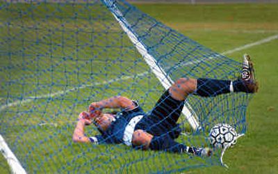 
Lake City defender Alex Day sprawls on the ground near the back of the net after a futile attempt to stop a goal by Coeur d'Alene in the regional championship match. 
 (Jesse Tinsley / The Spokesman-Review)