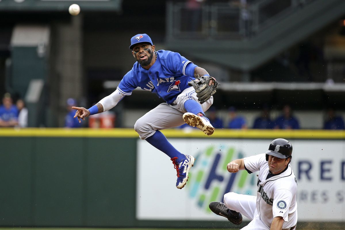 Blue Jays SS Jose Reyes leaps out of the way after forcing out Mariners