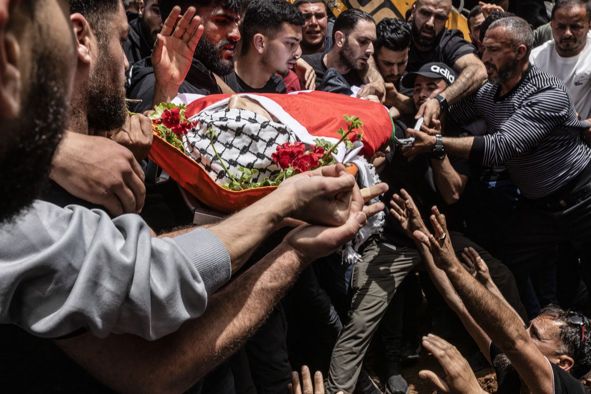 Mourners lower the body of Palestinian American Amer Rabee during his funeral on Monday.   (Heidi Levine/For The Washington Post)