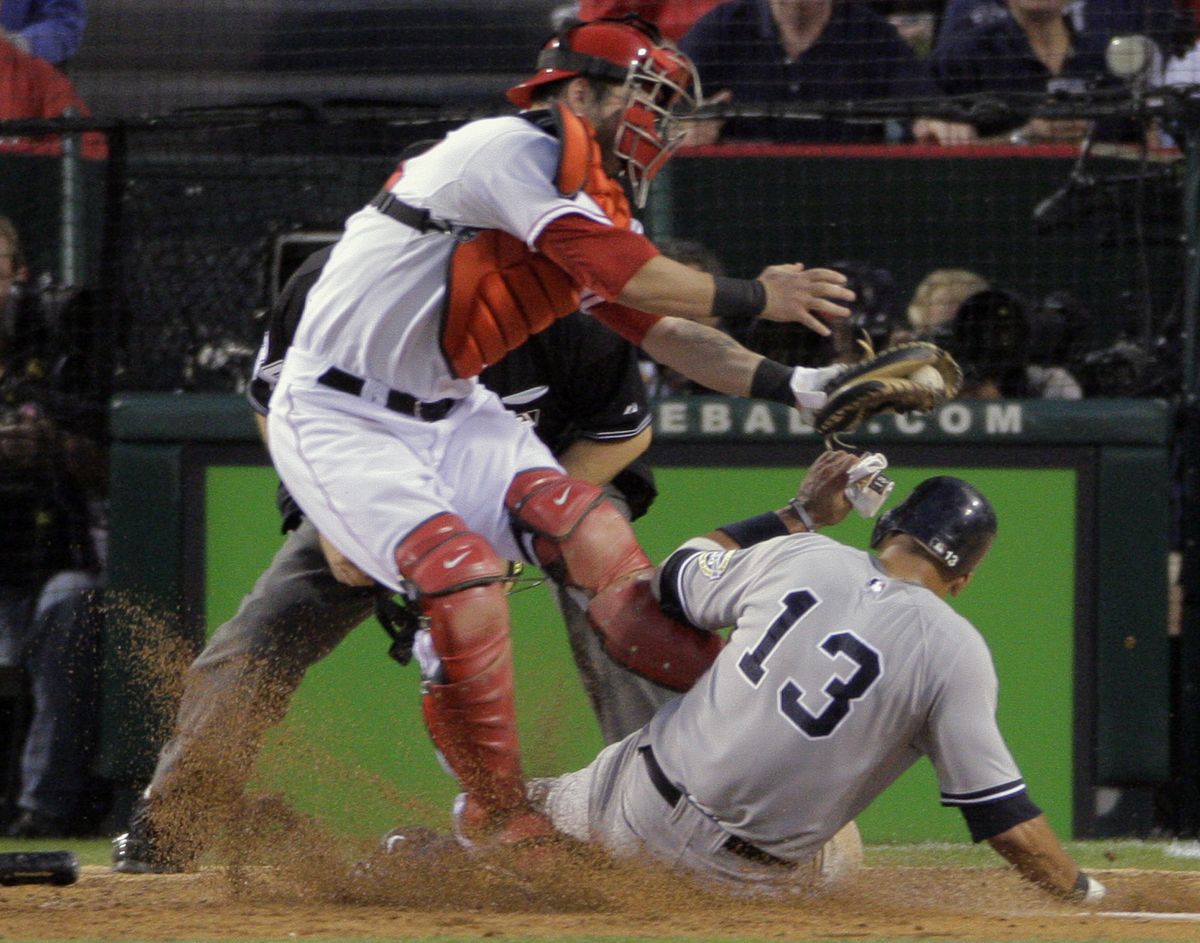 Yankees’ Alex Rodriguez scores under the tag of Angels catcher Mike Napoli.  (Associated Press / The Spokesman-Review)