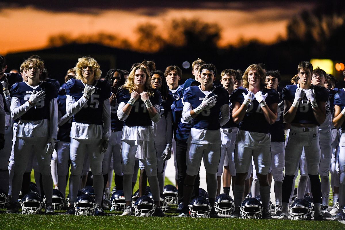 The Gonzaga Prep Bullpups gather for a prayer and the singing of The Star-Spangled Banner before their game playoff high school football game with the Chiawana Riverhawks, Friday, Nov. 5, 2021.  (COLIN MULVANY/THE SPOKESMAN-REVIEW)
