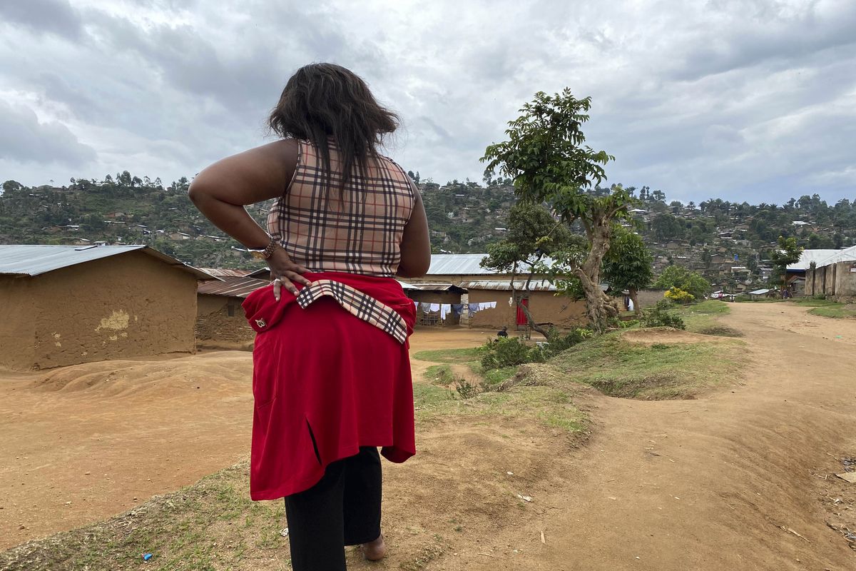 Shekinah stands near her home in Beni, eastern Congo on Thursday, March 18, 2021. When she was working as a nurse’s aide in northeastern Congo in January 2019, she said World Health Organization Dr. Boubacar Diallo, of Canada, offered her a job investigating Ebola cases at double her previous salary _ with a catch. "When he asked me to sleep with him, given the financial difficulties of my family….I accepted.”  (Kudra Maliro)