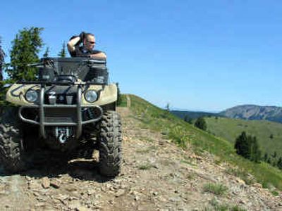 
Shoshone County Sheriff's Department Sgt. Tom Pipkin pays a visit recently to a remote area south of Kellogg where an ATV rider suffered a broken leg. 
 (James Hagengruber / The Spokesman-Review)