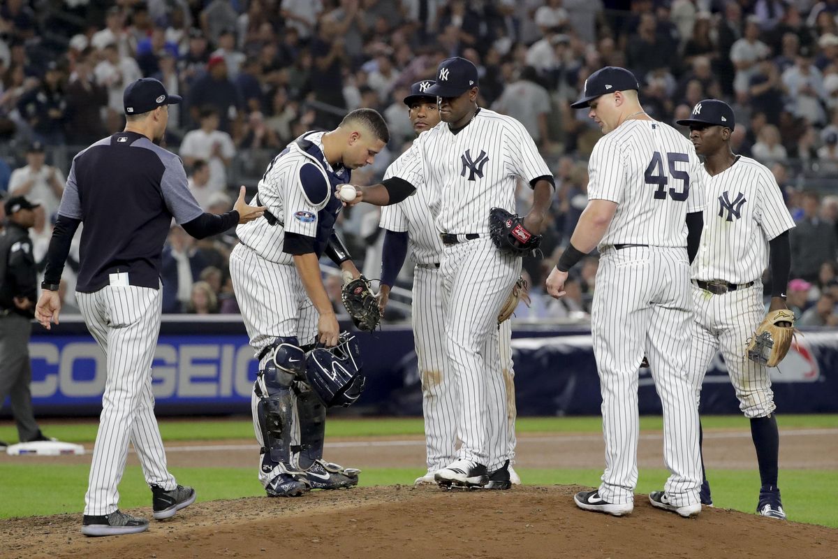 New York Yankees starting pitcher Luis Severino, center, hands the ball to manager Aaron Boone as he is relieved during the fifth inning against the Oakland Athletics on Wednesday in New York. (Frank Franklin II / AP)