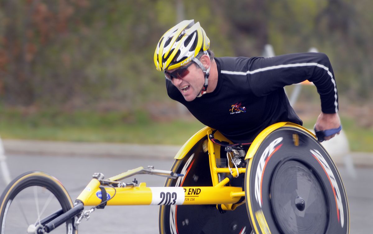 Krige Schabort, a 45-year-old South African who resides in Georgia, tops Doomsday Hill alone on the way to first place in the men’s wheelchair division.  (Jesse Tinsley / The Spokesman-Review)