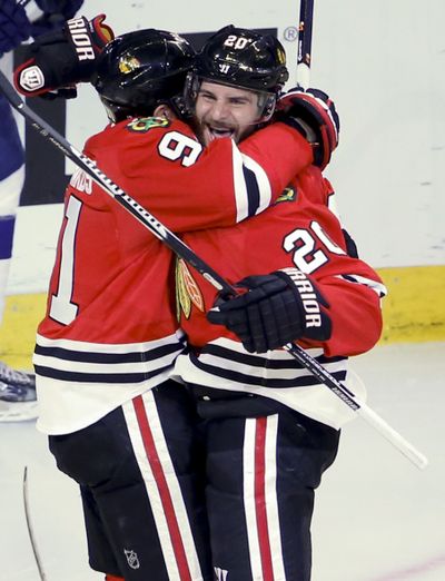 Chicago’s' Brandon Saad, right, is congratulated by Brad Richards after scoring third-period goal. (Associated Press)