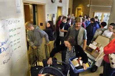 
The lobby elevators at EWU's Pearce Hall dorm are crammed with families trying to get students moved in for the new academic year. Classes start Wednesday. 
 (Christopher Anderson/ / The Spokesman-Review)