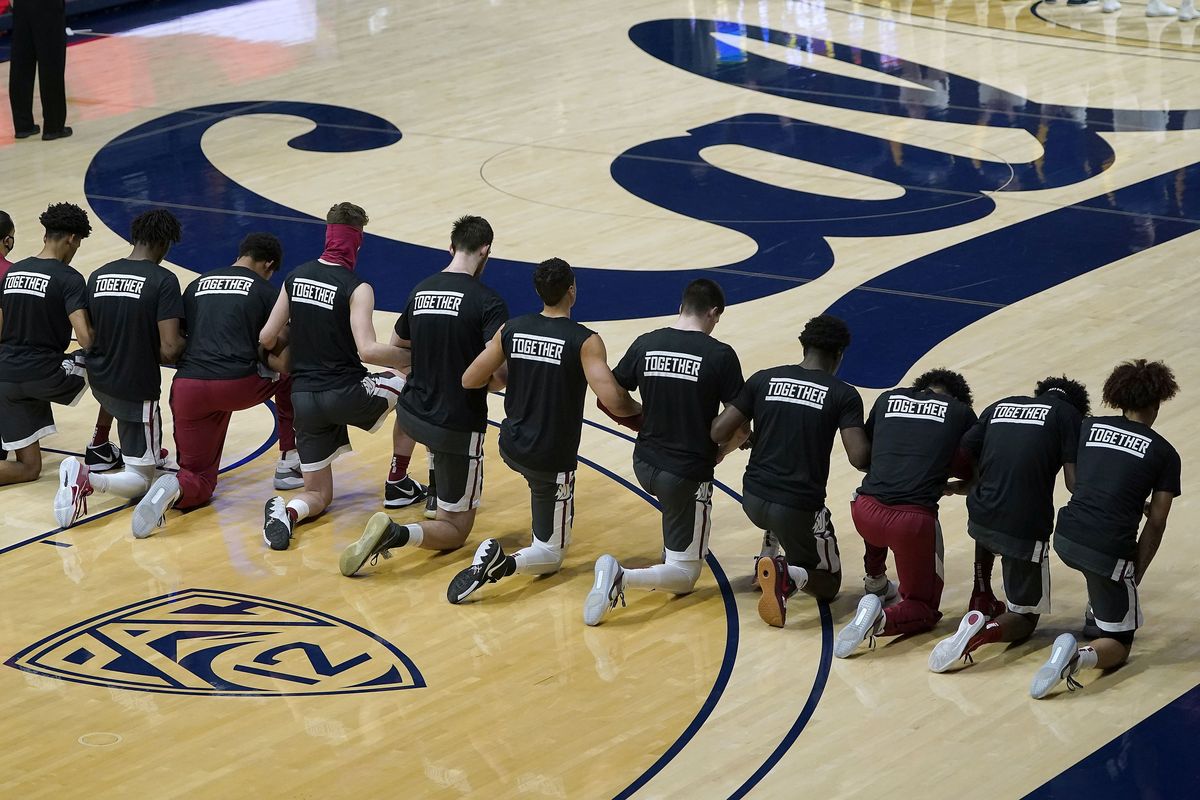 Eleven of Washington State’s players kneel during the national anthem before a Pac-12 Conference game against California on Jan. 7 in Berkeley, Calif.  (Associated Press)