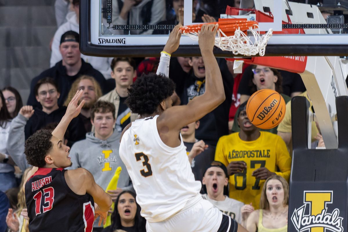 Idaho forward Isaac Jones, right, slips past Eastern Washington forward Angelo Allegri to dunk the ball in the first half on Saturday, Feb. 11, 2023, at the ICCU Arena in Moscow, Idaho.  (Geoff Crimmins/For The Spokesman-Review)