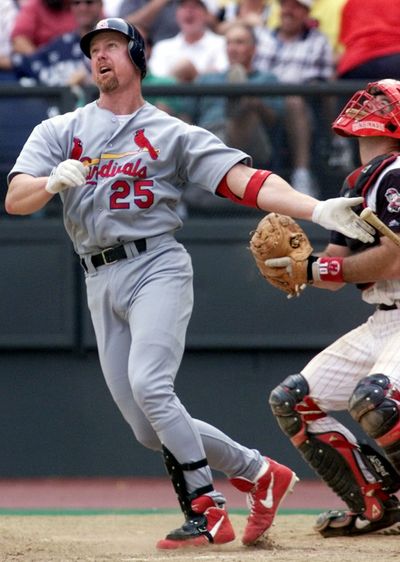 Mark McGwire watches his 60th home run leave the yard on Sept, 26, 1999.   (FILE Associated Press)