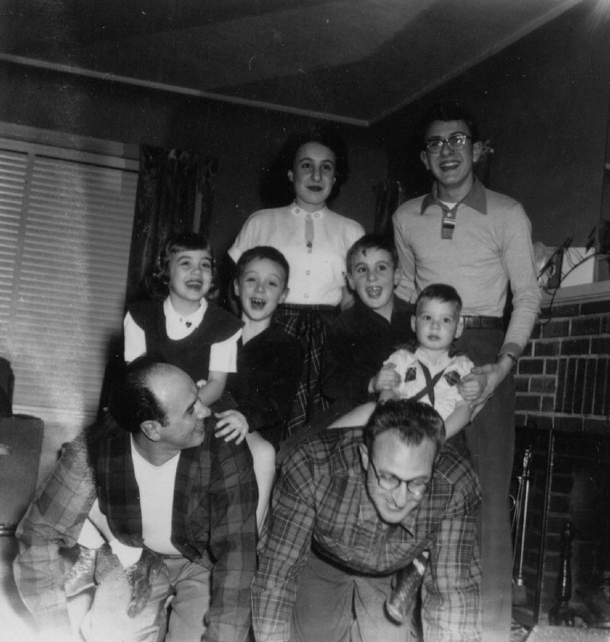 Fruci-Sacco-Perry family members horse around at a 1953 family dinner. The “horses” are Ernie Sacco and Tony Perry. The little kids, from left, are Christine Sacco, Paul Fruci, Bob Perry and Mike Sacco. In back, Janet Perry and Rich Perry. 