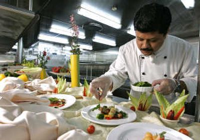 
Soumen Banerjee, head chef aboard the Carnival cruise ship Imagination, prepares healthier dishes to be served aboard the ship last week  before leaving  Miami. Associated Press
 (Associated Press / The Spokesman-Review)