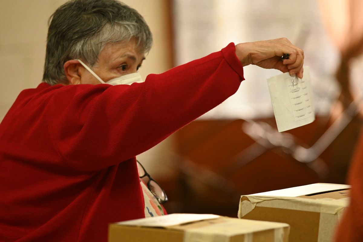 A woman casts her vote during general elections in San Jose, Costa Rica, Sunday, Feb. 6, 2022. Costa Ricans will choose a new president and National Assembly in the elections that are taking place days after the country