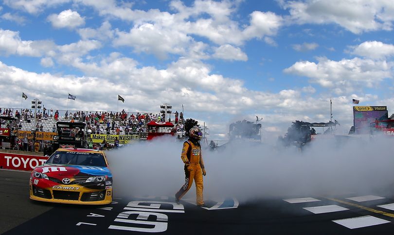 Kyle Busch, driver of the #18 M&M's Toyota, celebrates with a burnout after winning the NASCAR Sprint Cup Series Cheez-It 355 at The Glen at Watkins Glen International on August 11, 2013 in Watkins Glen, New York. (Photo Credit: Todd Warshaw/Getty Images) (Todd Warshaw / Getty Images North America)