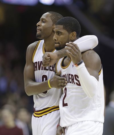 Cleveland’s C.J. Miles, left, congratulates Kyrie Irving after Irving hit the game-winner during the second overtime against the 76ers. (Associated Press)