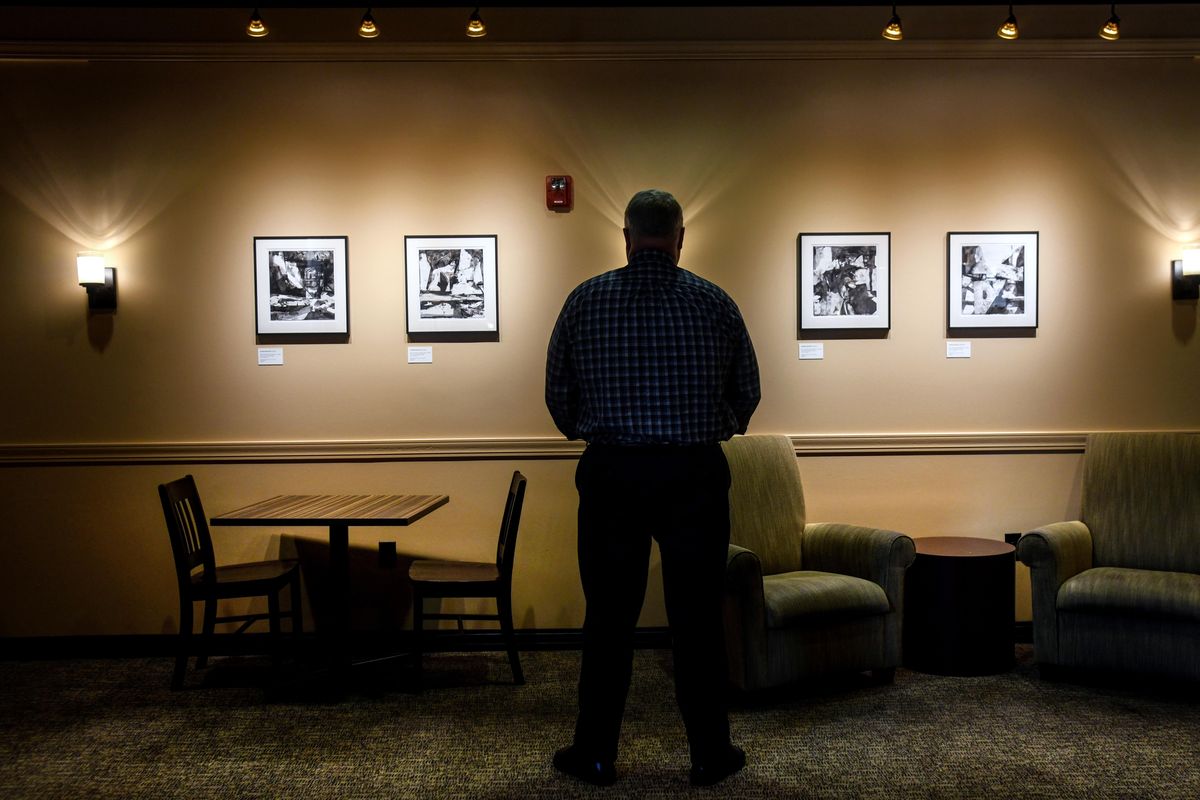 Tad Wisenor, Associate Vice President, Institutional Advancement at Whitworth University, view the work of Ben Frank Moss haning in the Hixson Union Building, Thursday, Aug. 15, 2019. Moss recently passed away. He lived and taught in the area as an artist. Over one million dollars of his paintings are displayed at Whitworth. (Dan Pelle / The Spokesman-Review)