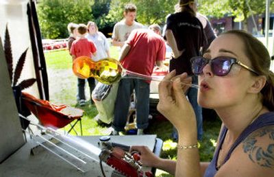 
Glass artist Stacey Miotke blows a handheld water pipe at Hempfest on Sunday. 
 (Joe Barrentine / The Spokesman-Review)