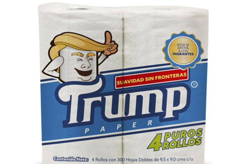 This illustration released by Antonio Battaglia shows toilet paper wrapped in mock-up packaging, featuring a cartoon image in the likeness of President Donald Trump, with the Spanish phrases “Softness without borders,” center, “This supports migrants,” top right, “Four pure rolls,” bottom right, which is a play on words in Spanish that roughly translates as “Pure nonsense.” (Antonio Battaglia / Associated Press)