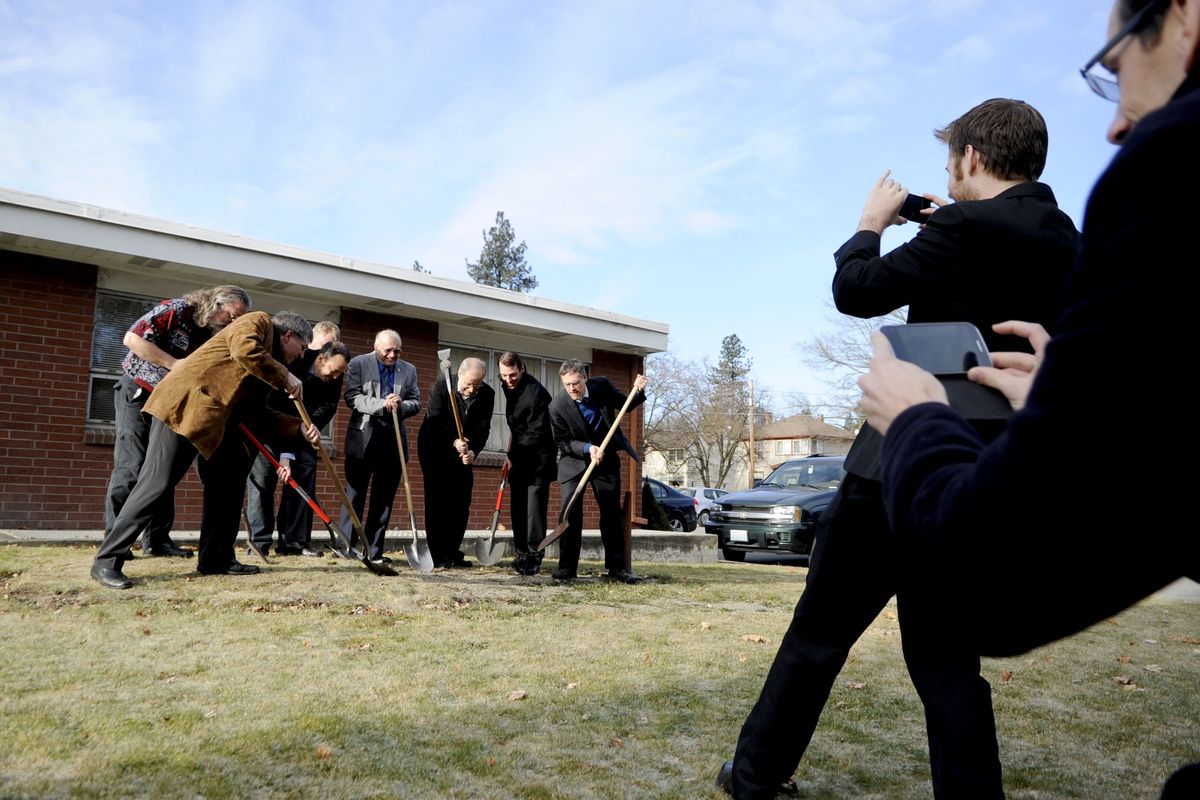 Folks scramble for pictures of the groundbreaking of the Peaceful Valley Youth Center at All Saints Lutheran Church in Browne’s Addition on Friday. (Kathy Plonka)