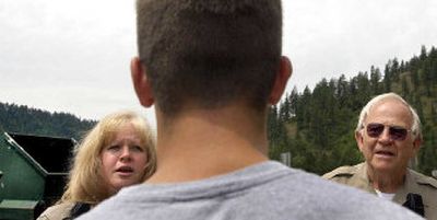 
Dawn Pearson, left, and Don Sherfey, of the Kootenai County Sheriff's Department COPs program, talk with Joe Scheideler about proper use of a Dumpster site  Thursday.
 (Kathy Plonka / The Spokesman-Review)