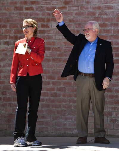 Former Rep. Gabrielle Giffords and Ron Barber enter the polling place at St. Cyril's Catholic Church in Tucson, Ariz., on Tuesday morning. (Associated Press)