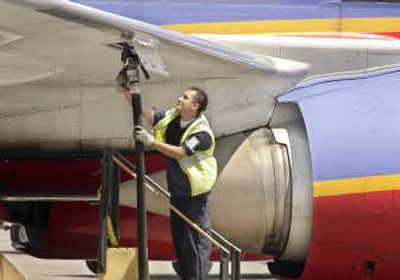 An aviation ground crew member pumps fuel into a Southwest Airlines' plane at Los Angeles International Airport. Since 1999, fuel hedging has saved Southwest $3.5 billion and sometimes meant the difference between profit and loss. FILE Associated Press
 (FILE Associated Press / The Spokesman-Review)
