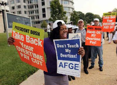 
A member of the American Federation of Government Employees marches during a protest over new overtime regulations outside Labor Department headquarters in Washington, D.C., on Monday. 
 (Associated Press / The Spokesman-Review)