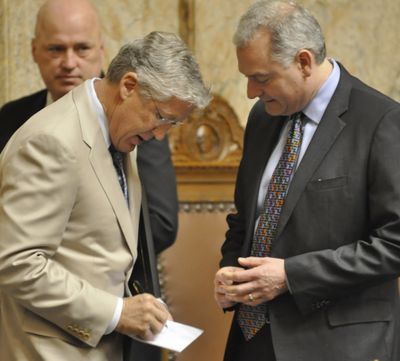 OLYMPIA -- Seattle Seahawks Head Coach Pete Carroll signs an autograph for Rep. Reuven Carlyle after the House presented him with a resolution supporting the team. (Jim Camden)