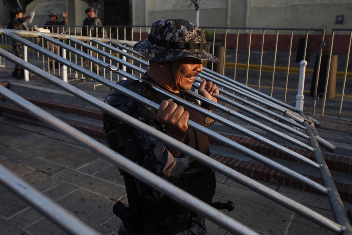 Municipal police officers secure the perimeter around the Cabanas Cultural Institute on Sunday prior to the North American Leaders Summit in Guadalajara, Mexico.  (Associated Press / The Spokesman-Review)