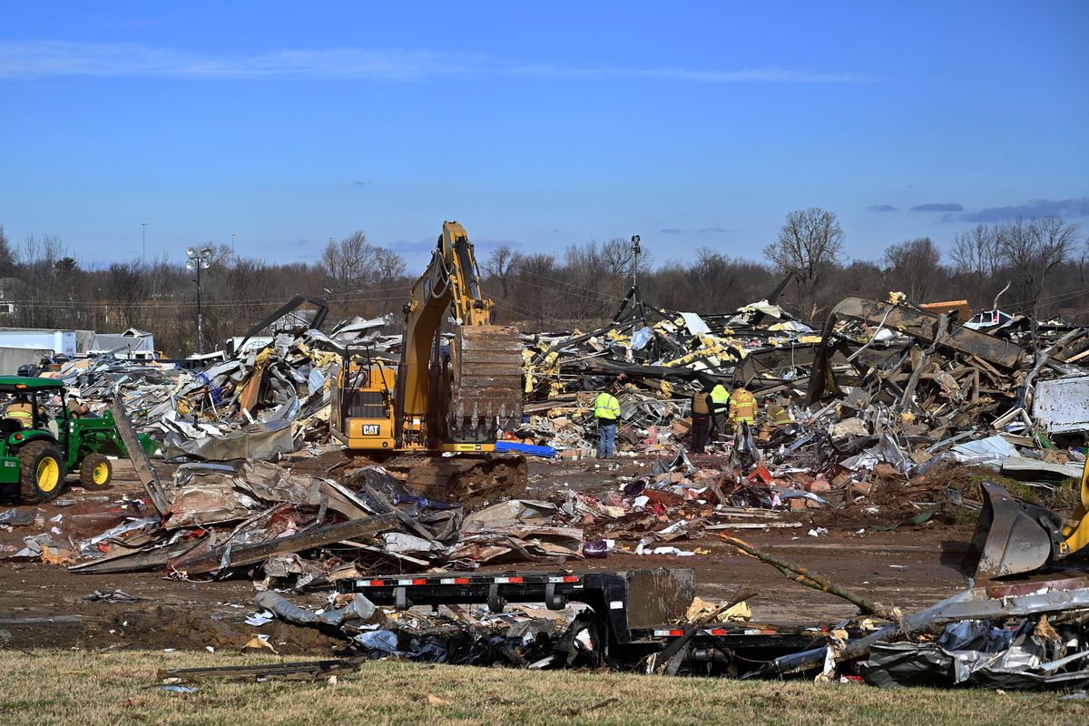 Emergency response workers dig through the rubble of the Mayfield Consumer Products candle factory in Mayfield, Ky., Saturday, Dec. 11, 2021. Tornadoes and severe weather caused catastrophic damage across multiple states late Friday, killing several people overnight.  (Timothy D. Easley)