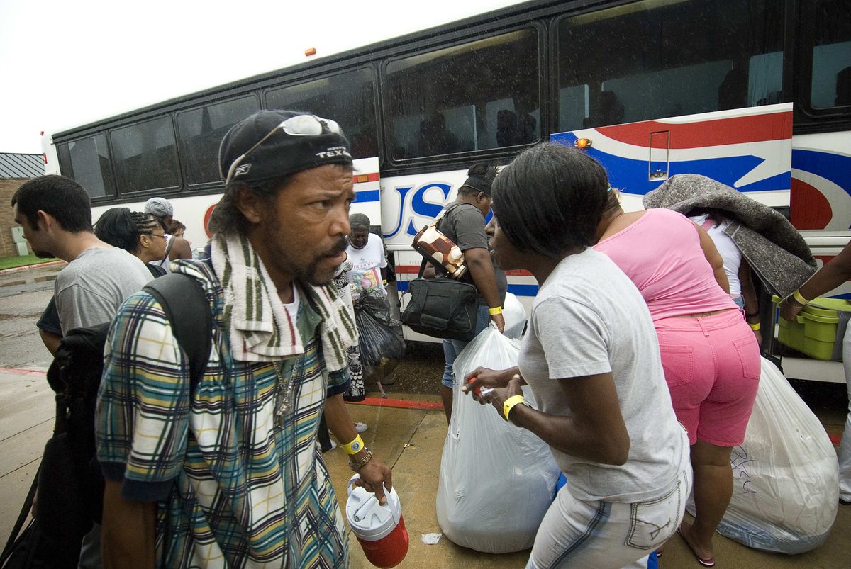 Port Arthur, Texas, evacuees load their belongings on to buses Wednesday to head home after spending four days in Texarkana, Texas. Associated Press photos (Associated Press photos / The Spokesman-Review)
