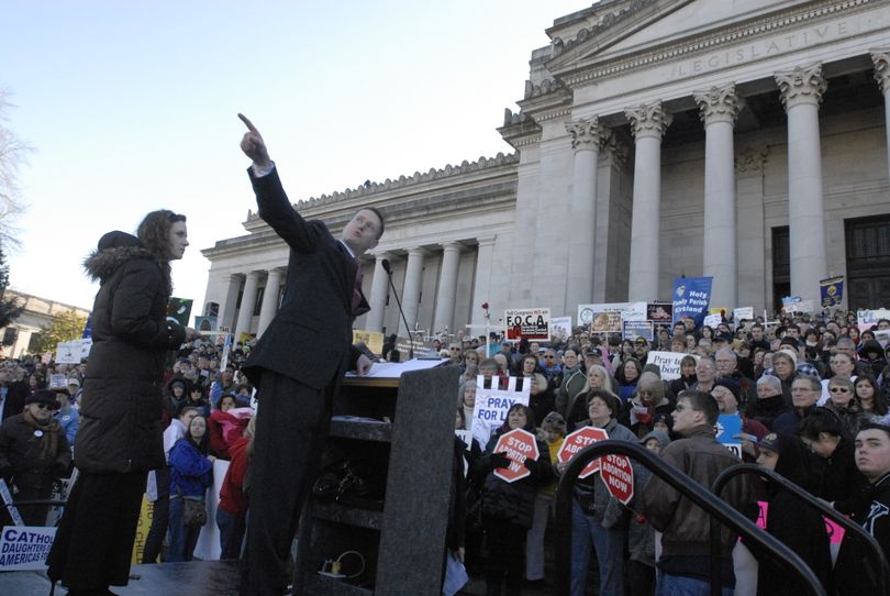 Standing before thousands at an anti-abortion rally Monday at the state capitol, Rep. Matt Shea gestures at about a dozen counter-demonstrators standing on the steps of the state Supreme Court.  (Rich Roesler / The Spokesman-Review)
