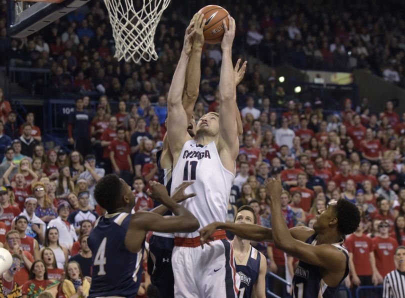 Gonzaga’s Domantas Sabonis (11) tries to pull down a rebound between Mount St. Mary’s players, including Khalid Nwandu (4), during the first half of an NCAA college basketball game, Saturday, Nov. 21, 2015, in Spokane, Wash. The Bulldogs resume their cross-state rivalry with Washington this morning in their first of three games at the Battle 4 Atlantis in the Bahamas. (AP Photo/Rajah Bose) 