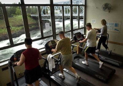 
YMCA members work out Wednesday while enjoying the  view of the Spokane River. The city of Spokane has the right of first refusal to buy the  downtown YMCA building and land. 
 (Dan Pelle / The Spokesman-Review)