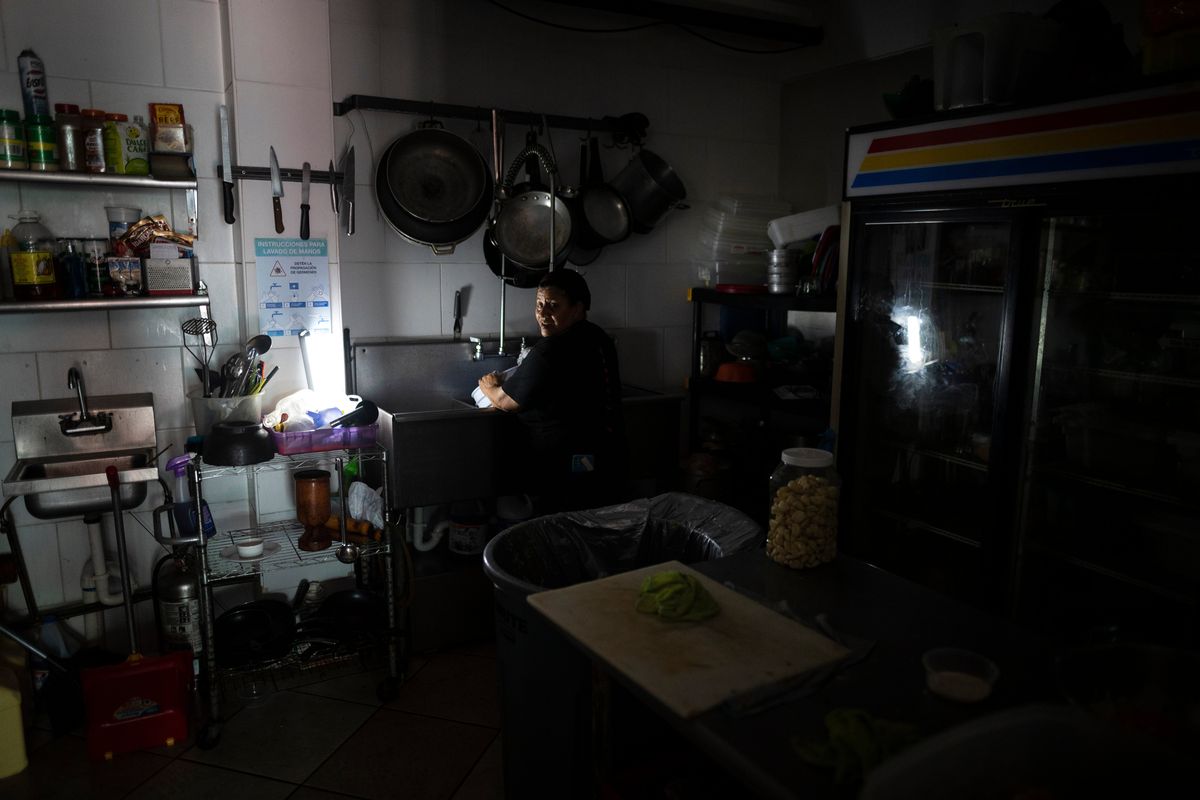 Workers at Las Palmas Cafe work with the power of an electricity generator during an island-wide blackout, in San Juan, Puerto Rico, Thursday, April 7, 2022. More than a million customers in Puerto Rico remained without electricity on Thursday after a fire at a main power plant caused the biggest blackout so far this year across the U.S. territory, forcing it to cancel classes and shutter government offices.  (Carlos Giusti)