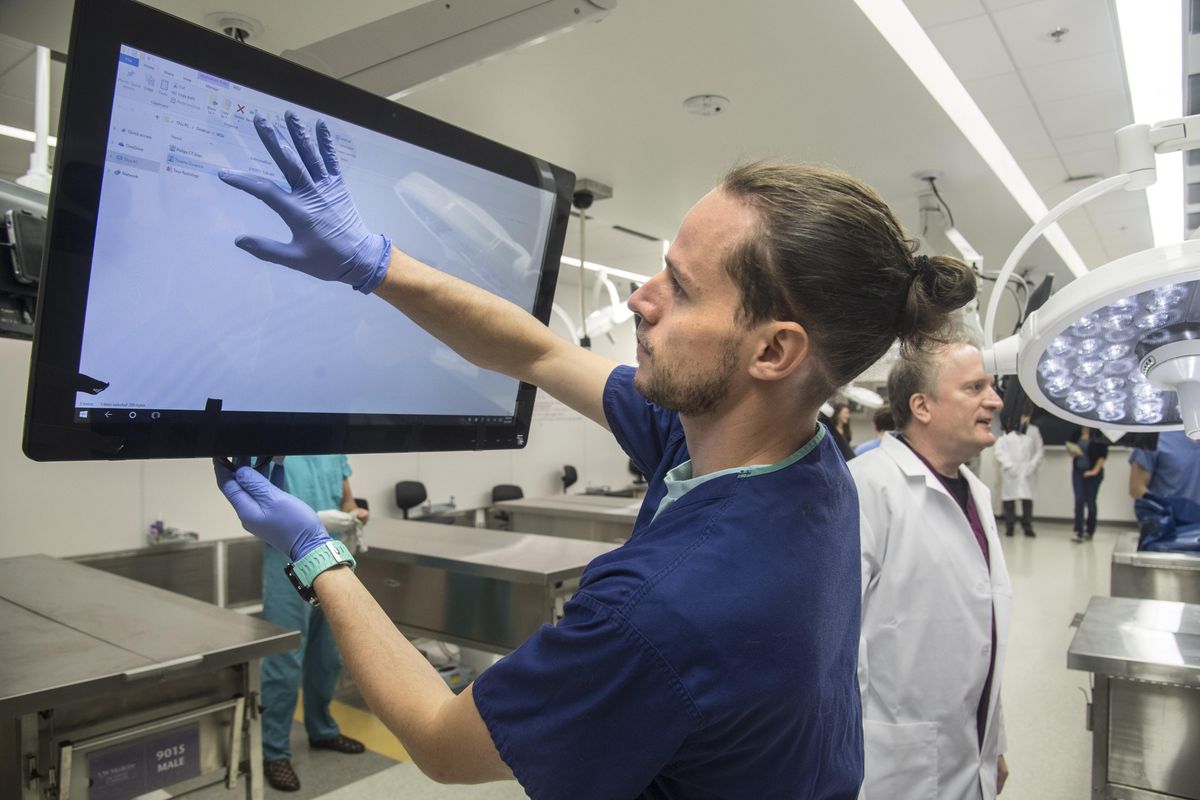 WSU medical student Julian Forhman, of Seattle, sets up a monitor before working on a female cadaver, Monday, Sept, 25, 2017, in Spokane. (Dan Pelle / The Spokesman-Review)