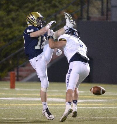 Gonzaga Prep's Jack Machtolf, right, blocks a kick by Mead punter Bryan Anderson, Friday, Sept. 18, 2015, at Joe Albi Stadium. (Jesse Tinsley / The Spokesman-Review)