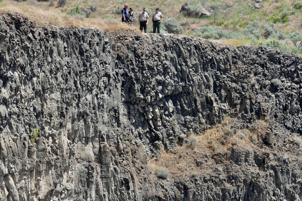 Law enforcement and rescue personnel look over a cliff above Palouse Falls Tuesday, May 30, 2017. A man fell from a cliff there Monday and his body recovered Tuesday afternoon. (Jesse Tinsley / The Spokesman-Review)