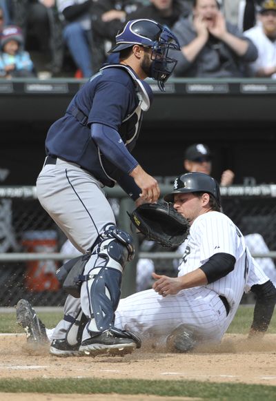 Chicago’s Conor Gillaspie slides home safe as Mariners catcher Kelly Shoppach fields late throw in fifth inning. (Associated Press)
