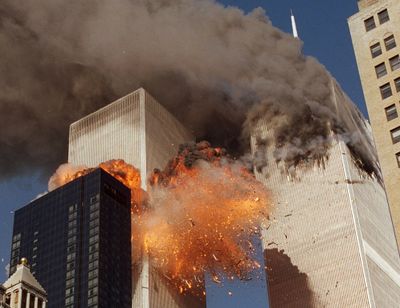 In this Sept. 11, 2001 photo, smoke billows from one of the towers of the World Trade Center and flames as debris explodes from the second tower in New York. Relatives of the victims of the Sept. 11 attacks called Thursday, Sept. 2, for the Justice Department's inspector general to investigate the FBI's failure to produce certain pieces of evidence from its investigation.  (Chao Soi Cheong)