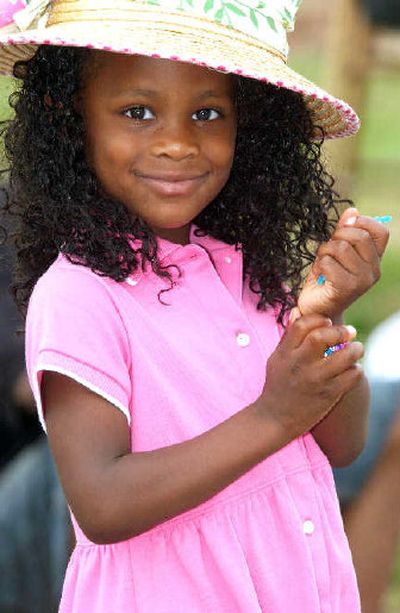 
Aaliyah Williams, 3, holds fistfuls of candy while attending a Juneteenth parade on Martin Luther King Jr. Blvd. in Tyler, Texas, on Saturday. 
 (Associated Press / The Spokesman-Review)