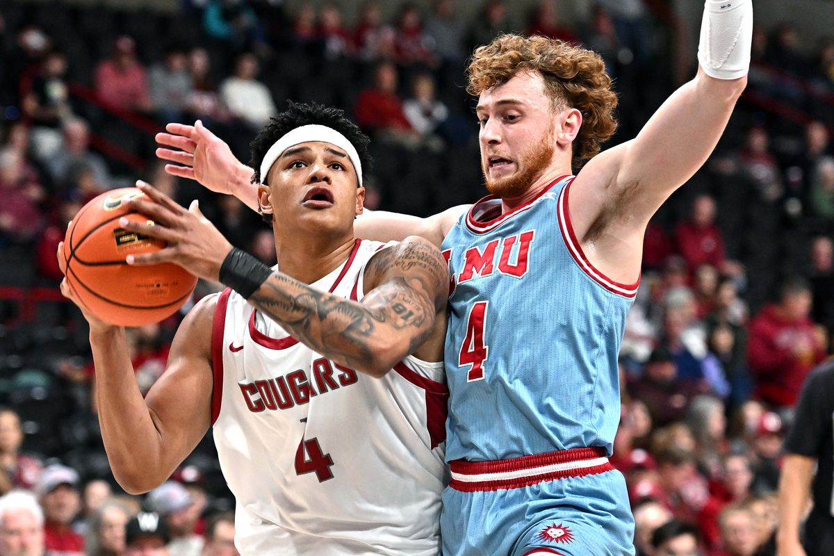 Washington State Cougars forward LeJuan Watts, left, goes up for a basket against Loyola Marymount Lions guard Will Johnston (4) in the first half on Mon. Dec. 30, 2024 at Spokane Veterans Memorial Arena in Spokane WA.  (James Snook/For The Spokesman-Review)